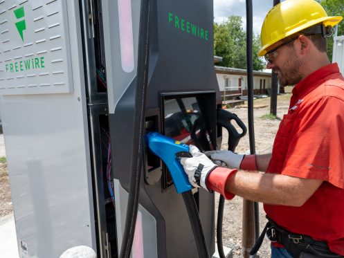 A gvec worker with an EV charger